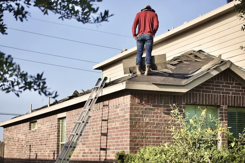 Professional roofer working on a residential roof in Dayton's Bluff